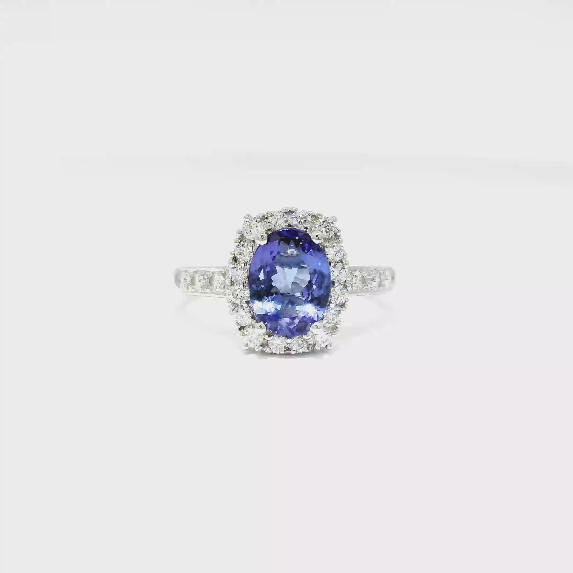 Oval Shaped Tanzanite Halo Style Ring in 18K White Gold